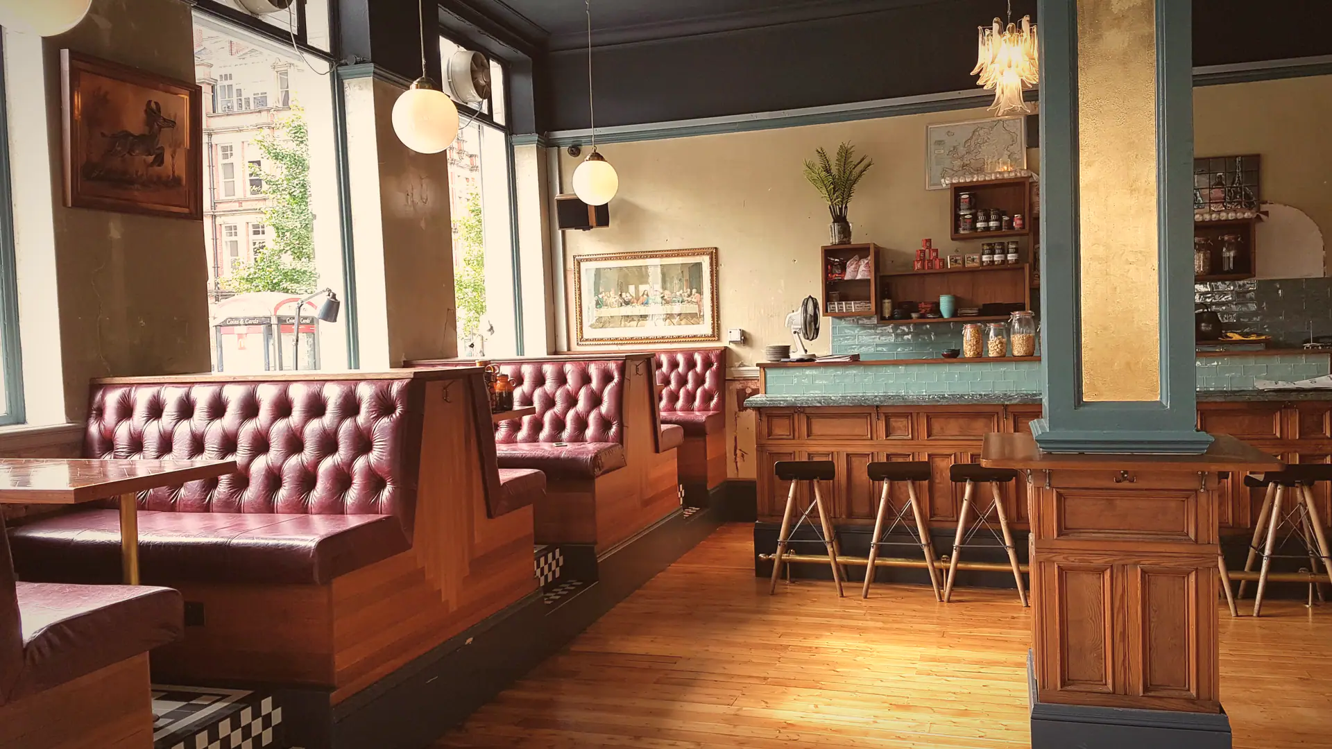 The ground floor at Flok: oxblood leather booths, chequerboard tiles and the green-tiled bar