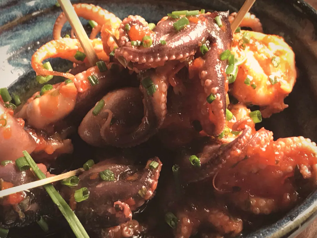 Baby octopus with smoked paprika in a blue dish at Flok
